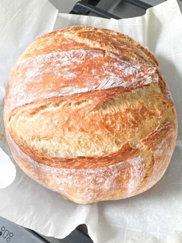 round loaf of homemade bread on parchment paper