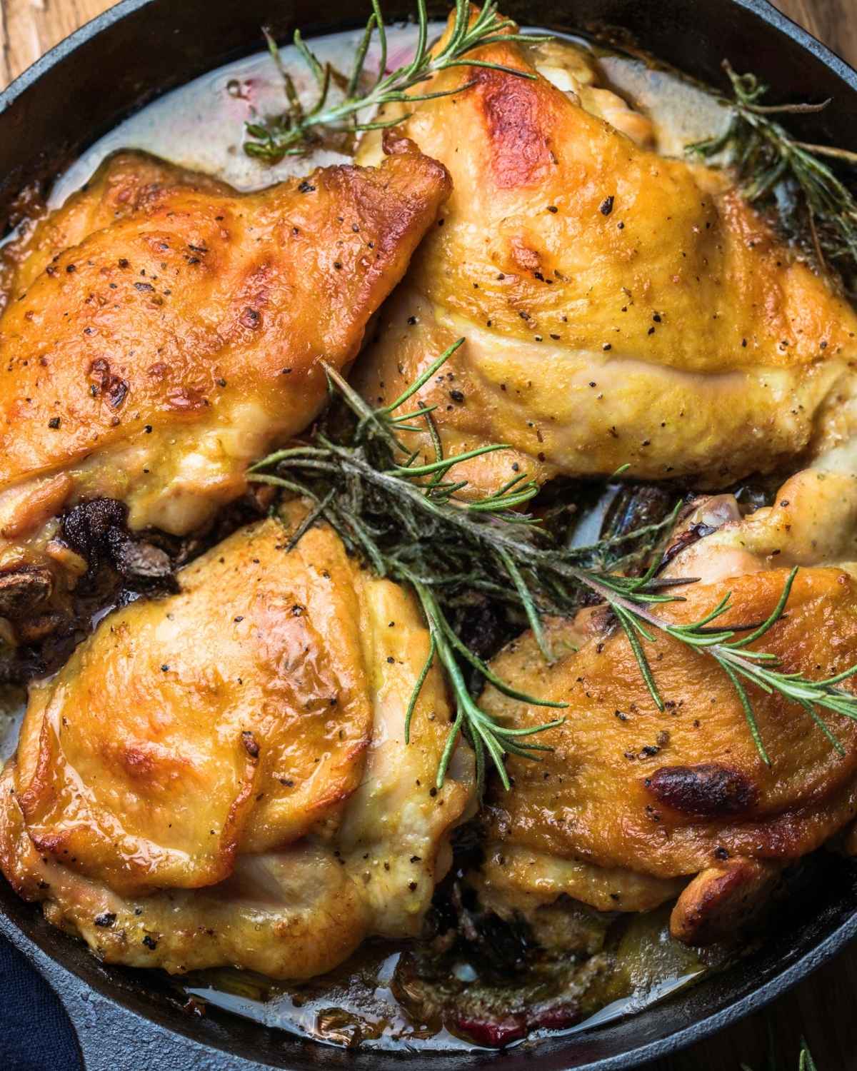 top view of cooked chicken thighs in a skillet