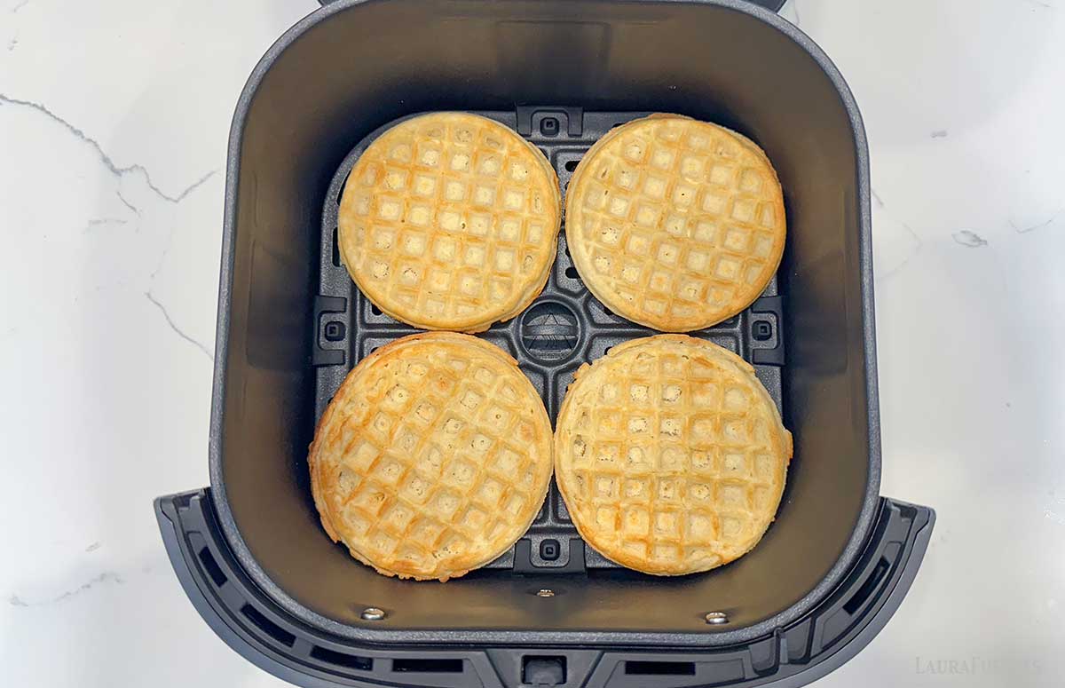 four fully cooked waffles in an air fryer