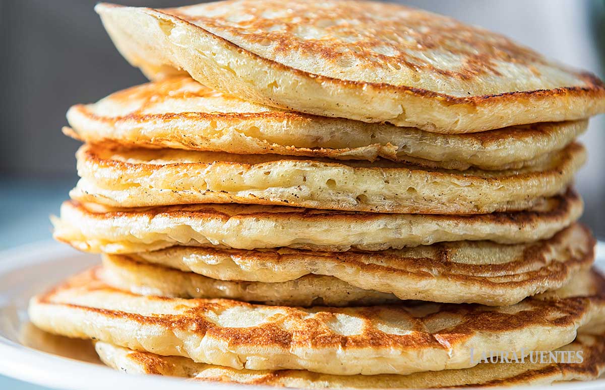 stack of fluffy pancakes on a white plate