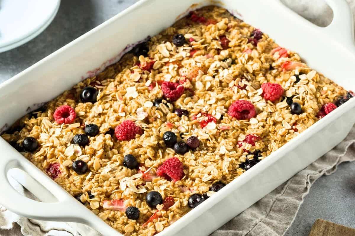 baked protein oatmeal with berries in a white baking dish