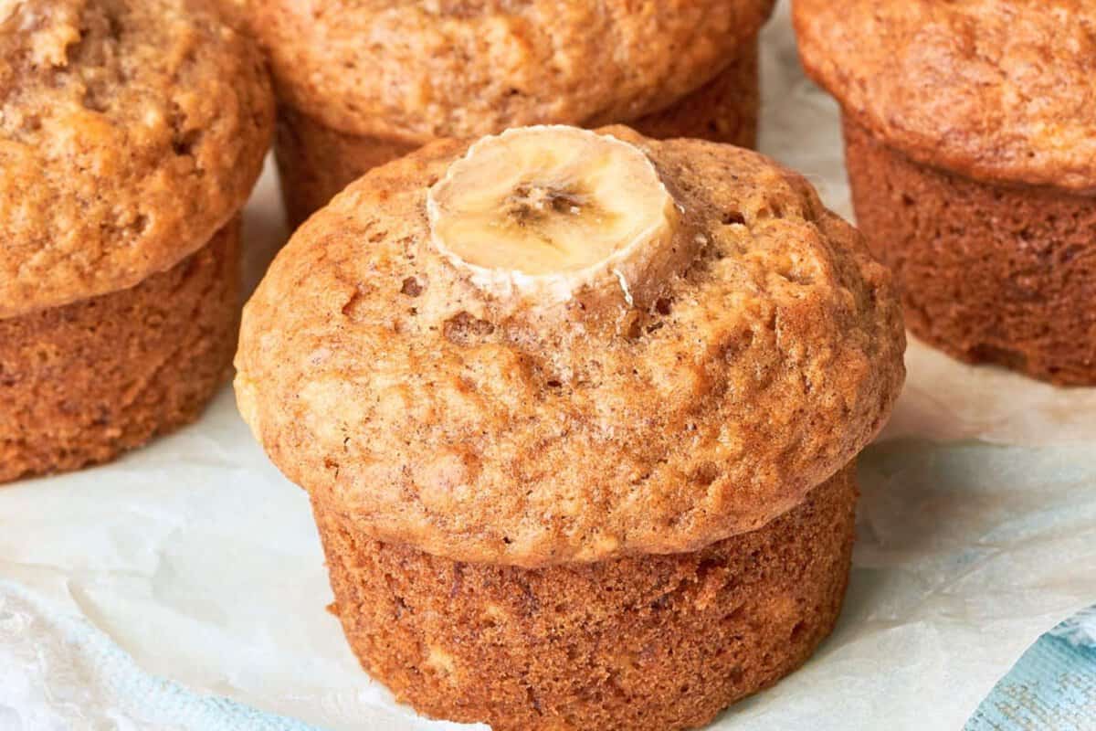 one banana muffin surrounded by other muffins