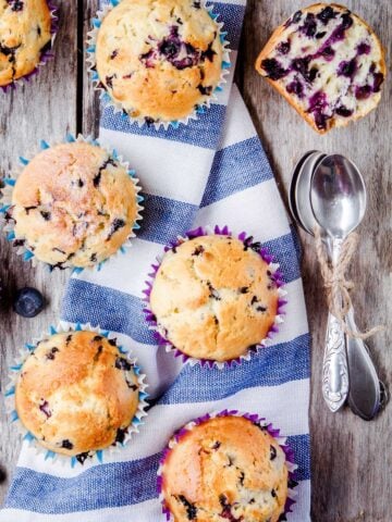 top view of seven blueberry muffins over a wooden table