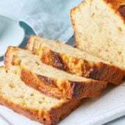 a banana bread sliced on a white dish