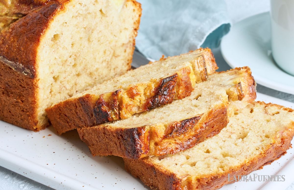 a banana bread sliced on a white dish