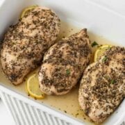 juicy baked chicken breasts with italian seasoning in a baking dish