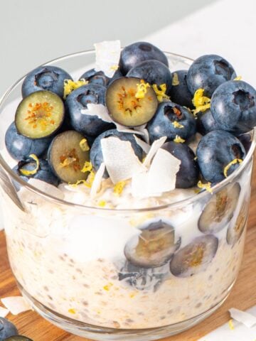 a jar of lemon overnight oats topped with blueberries