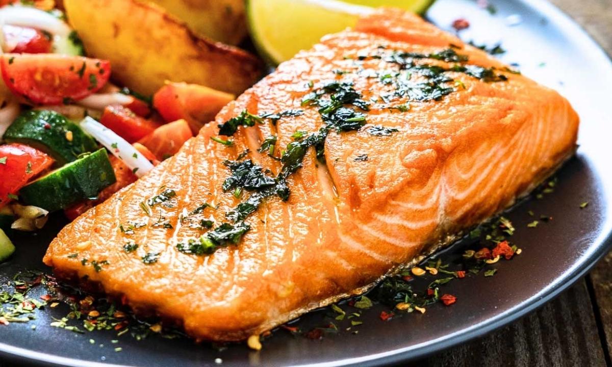 cooked salmon fillet served in a dish with veggies