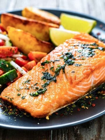 cooked salmon fillet served in a dish with veggies