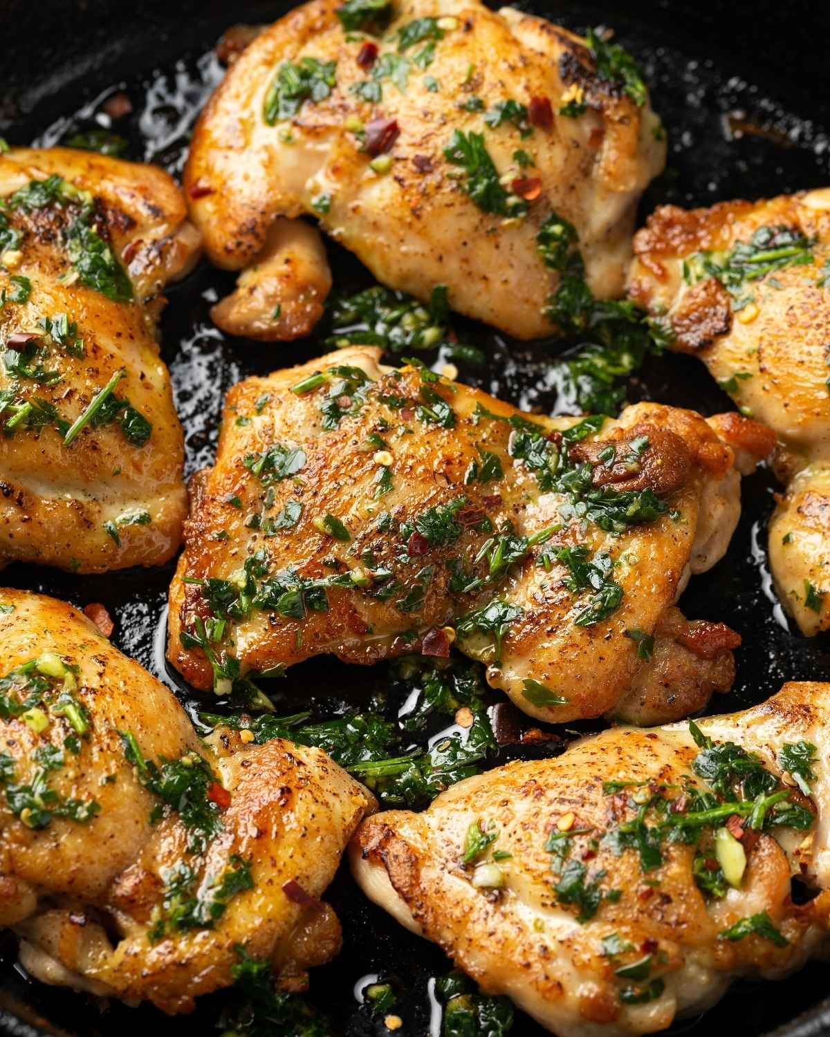top view of chimichurri chicken thighs in a skillet
