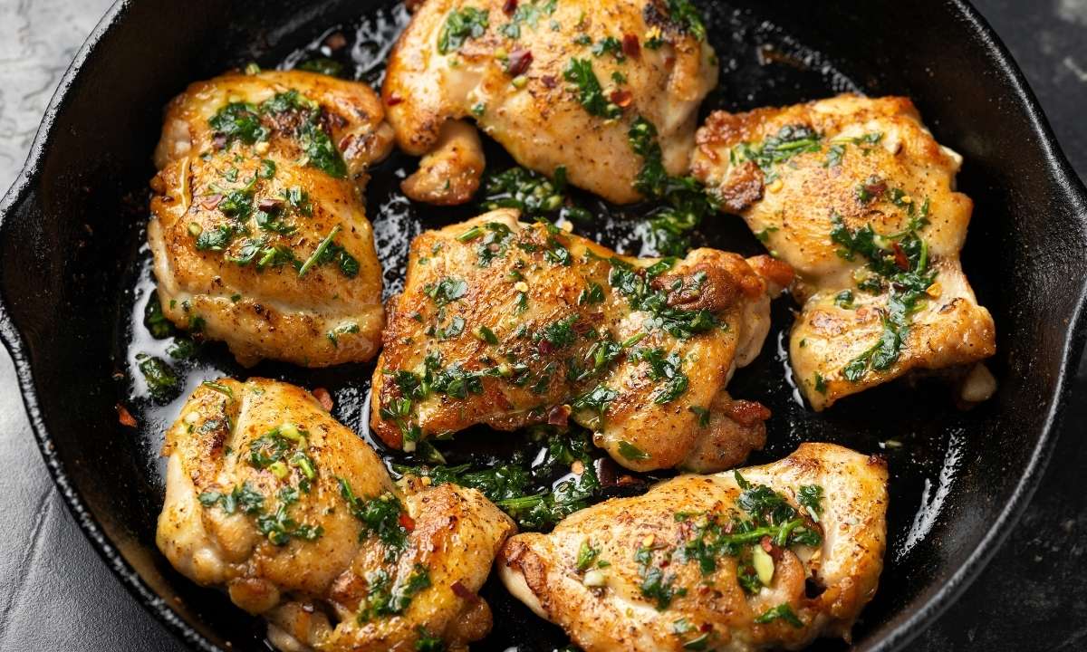 top view of chimichurri chicken thighs in a skillet