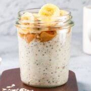 a jar of overnight oats with chia seeds topped with banana slices
