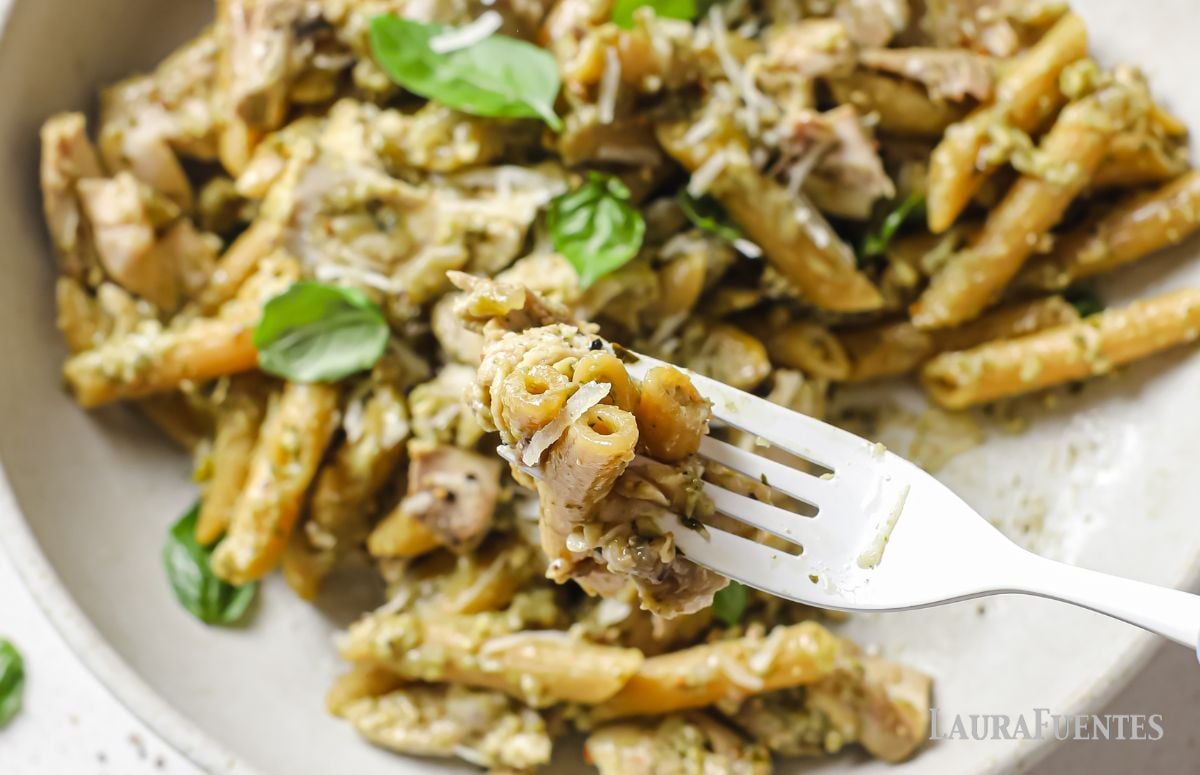 rotisserie chicken pesto pasta in a dish with a fork