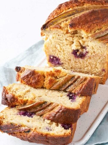 blueberry banana bread cut in slices on a tray