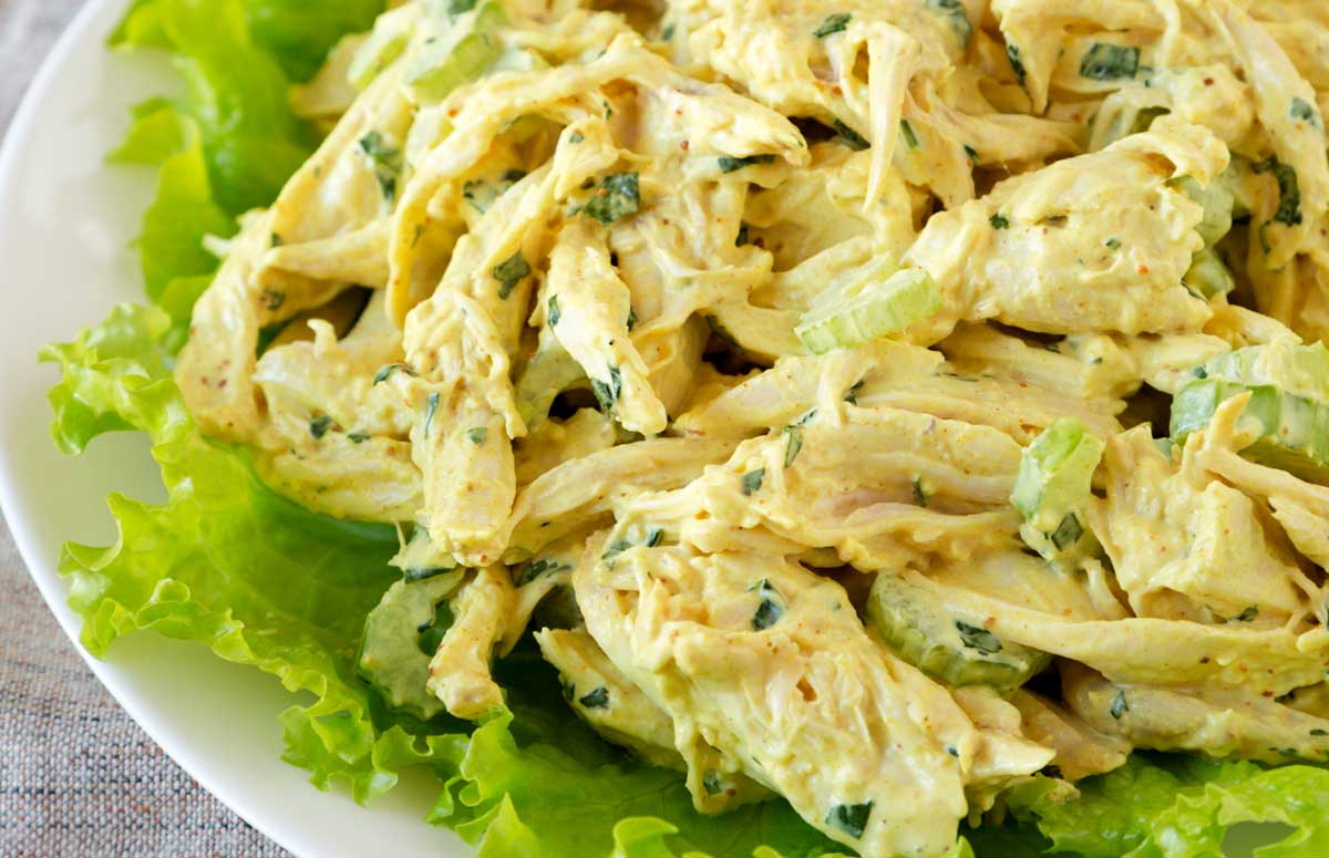 curry chicken salad over lettuce on a plate