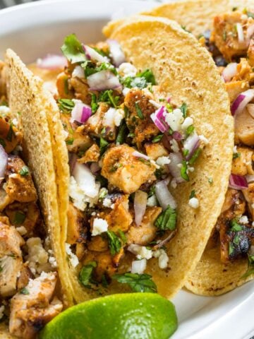 crunchy chicken thigh tacos in a white dish