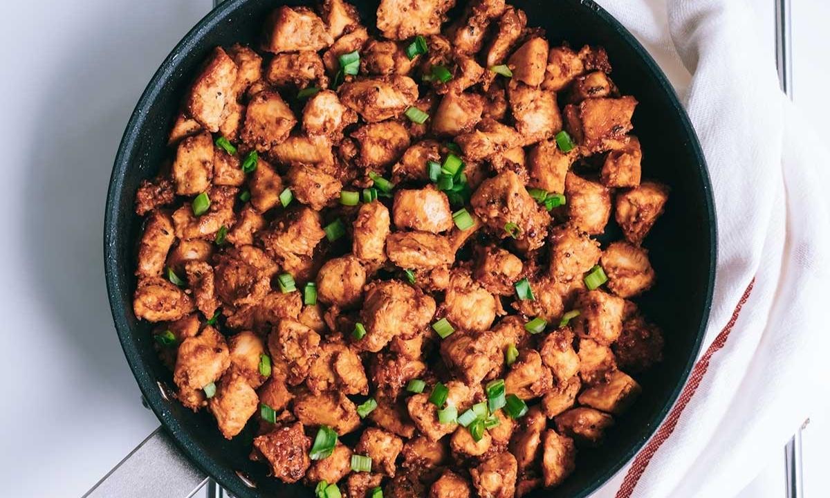 top view of cooked cubed chicken in a pan