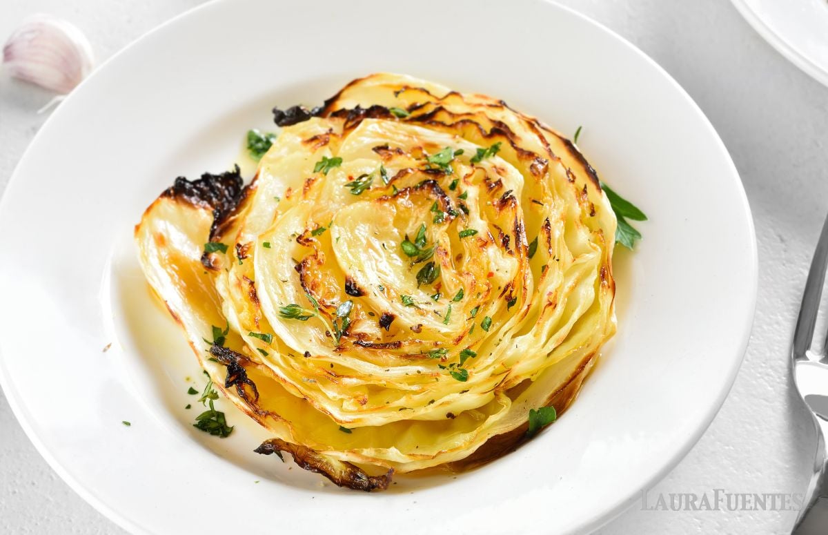 top view of roasted cabbage steaks in a white dish