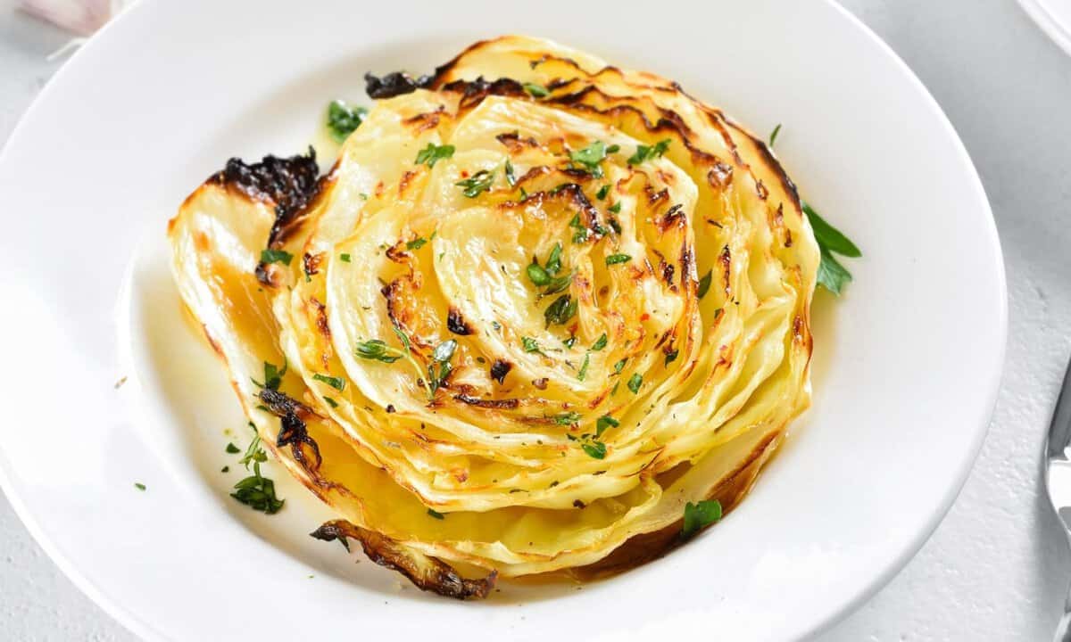 roasted cabbage steak in a white dish