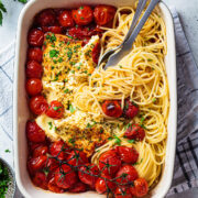 top view of a baking dish with baked feta spaghetti with cherry tomatoes