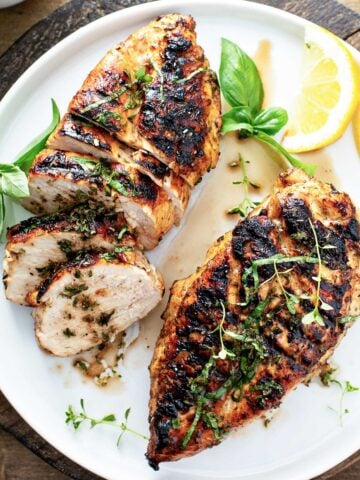 top view of 2 balsamic chicken breasts in a white dish