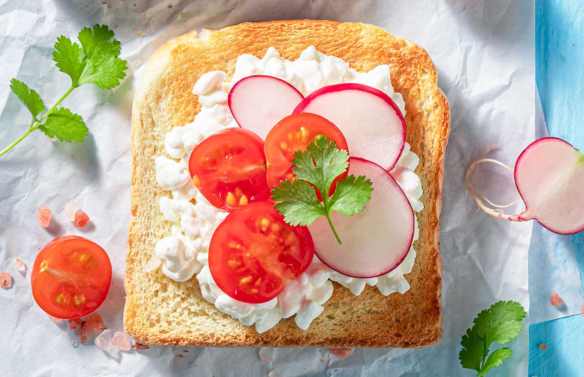 top view of toast with cottage cheese, radish, and tomato