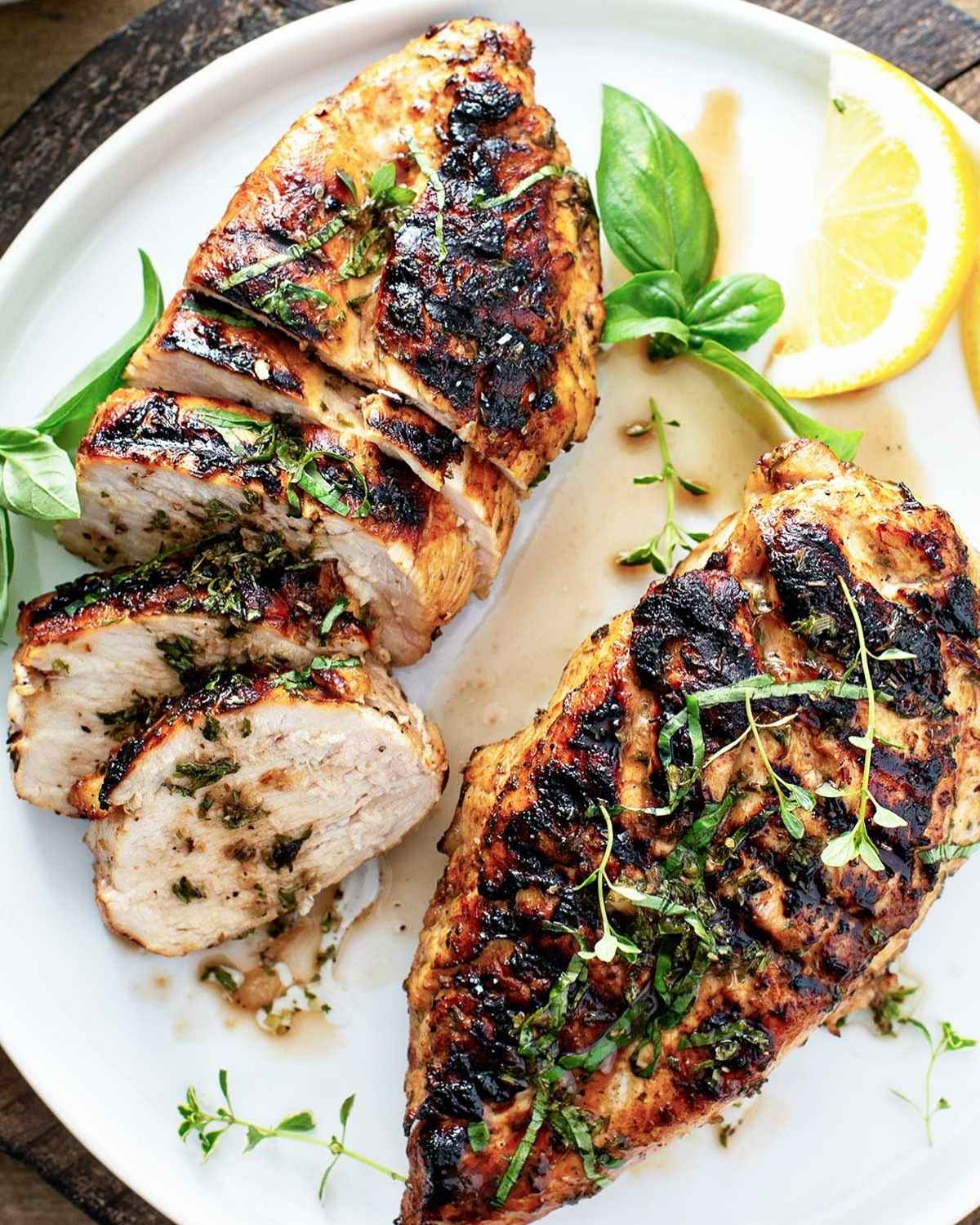 top view of 2 balsamic chicken breasts in a white dish