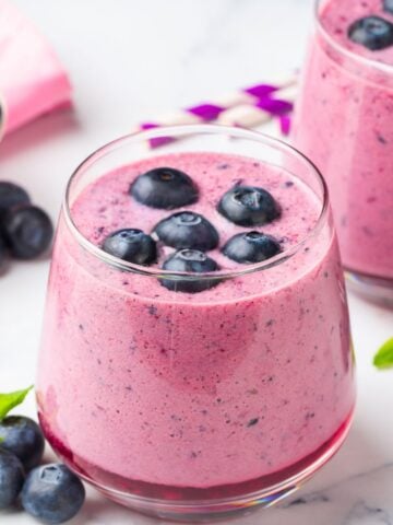 a blueberry cottage cheese smoothie with blueberries on top