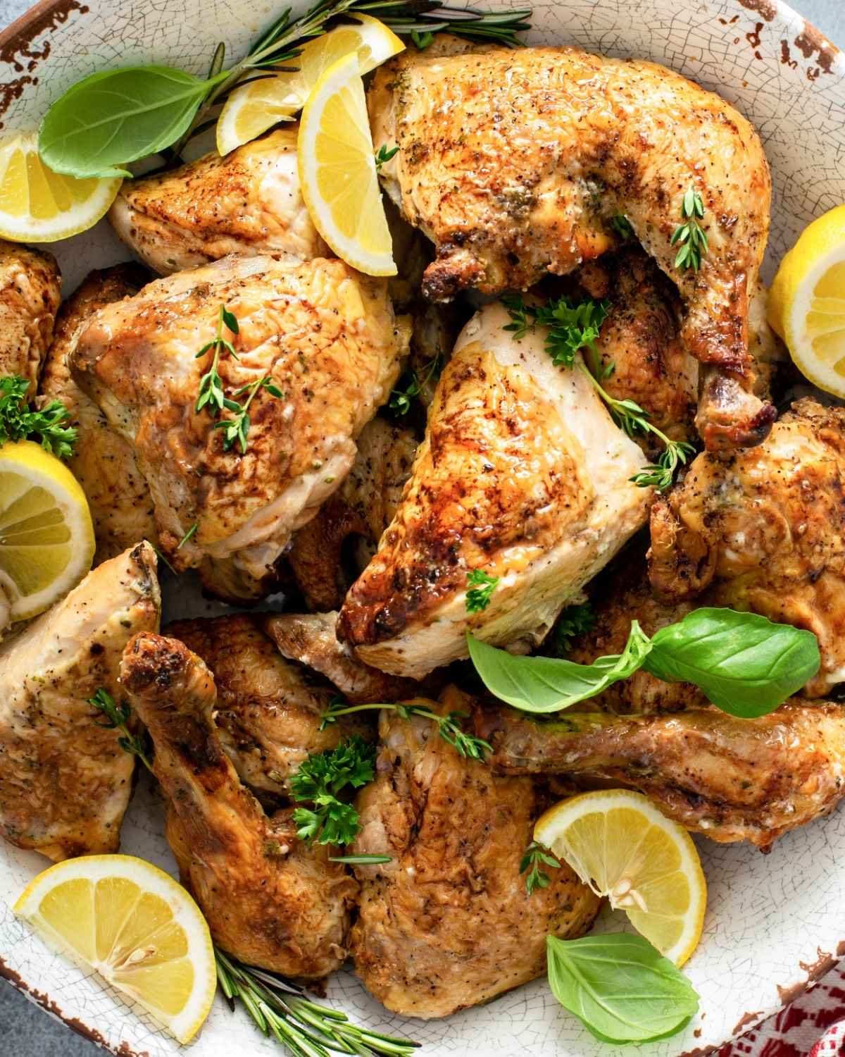 top view of lemon herb chicken pieces in a large bowl