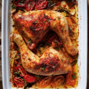two large chicken leg quarters with onions and tomatoes