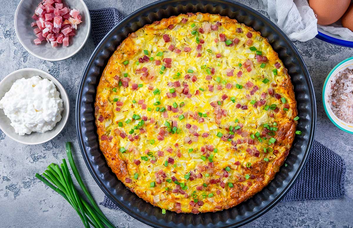 top view of a crustless cottage cheese quiche in a round pie dish