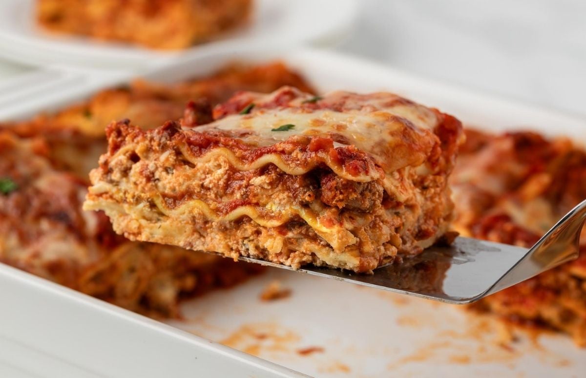 a sliced serving of cottage cheese lasagna on a serving spatula to show the meaty layers of the lasagna