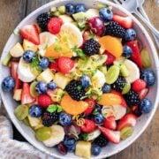 a bowl of summer fruit salad