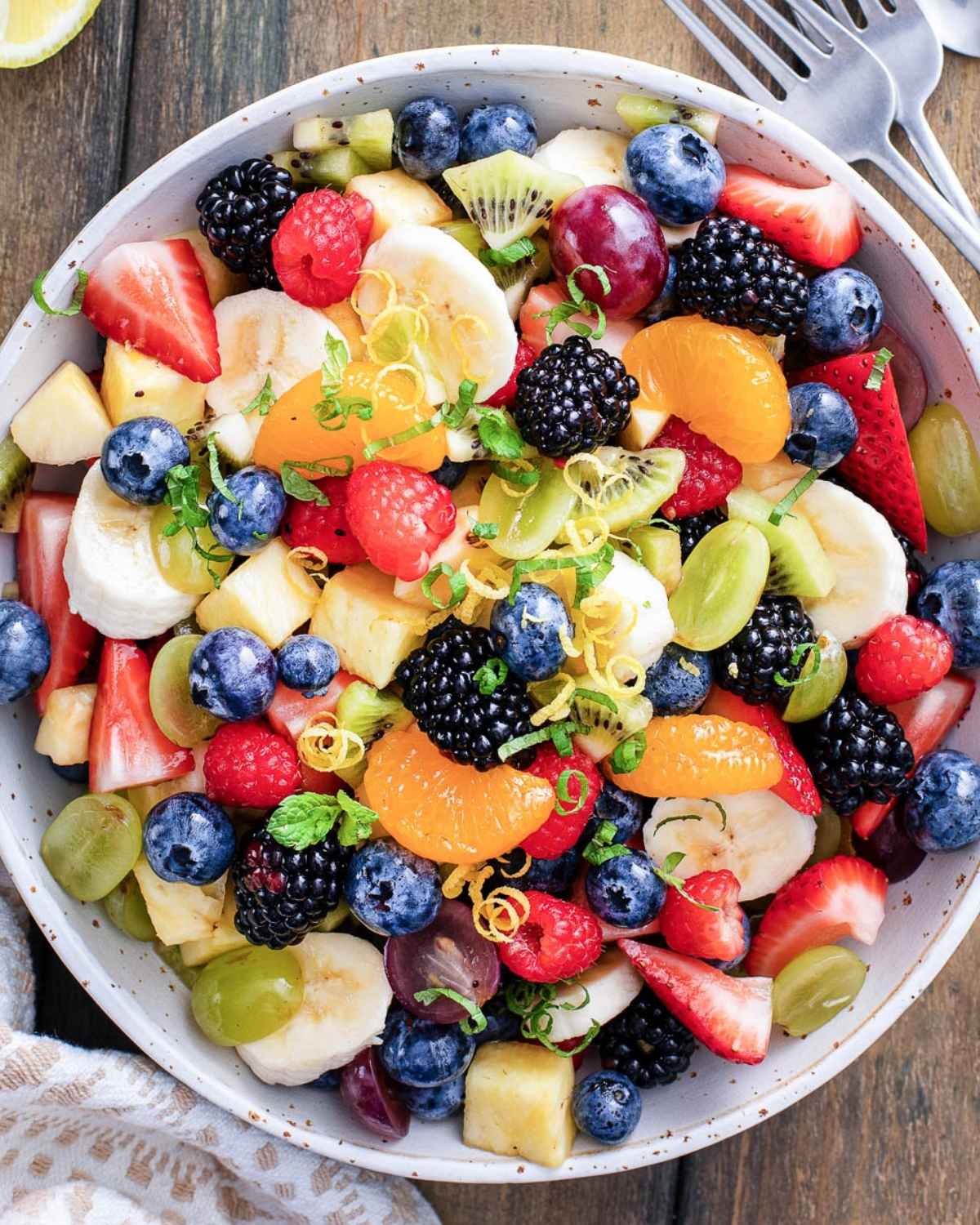 a bowl of summer fruit salad