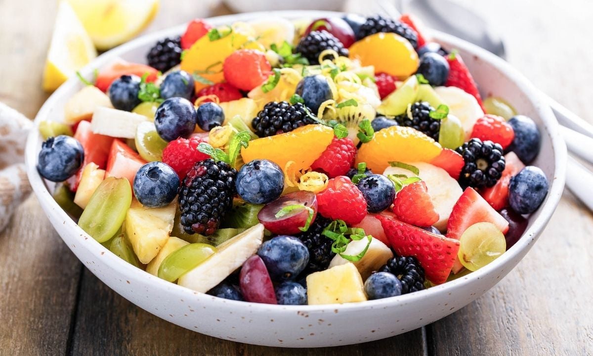 a bowl of summer fruit salad
