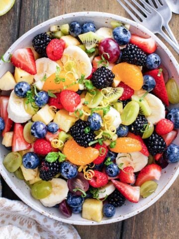 a bowl of summer fruit salad