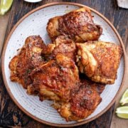 top view of a plate with five cumin chicken thighs