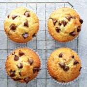 top view of four Greek yogurt banana muffins with chocolate chips on a cooling rack