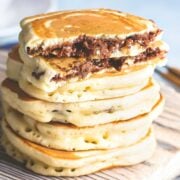 a stack of fluffy nutella pancakes where the nutella is stuffed inside.