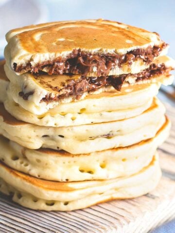 a stack of nutella pancakes where the nutella is stuffed inside.
