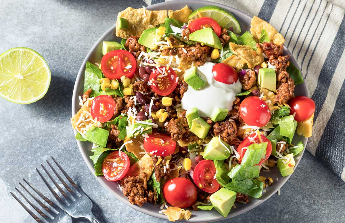 large taco bowl with a lime to the side