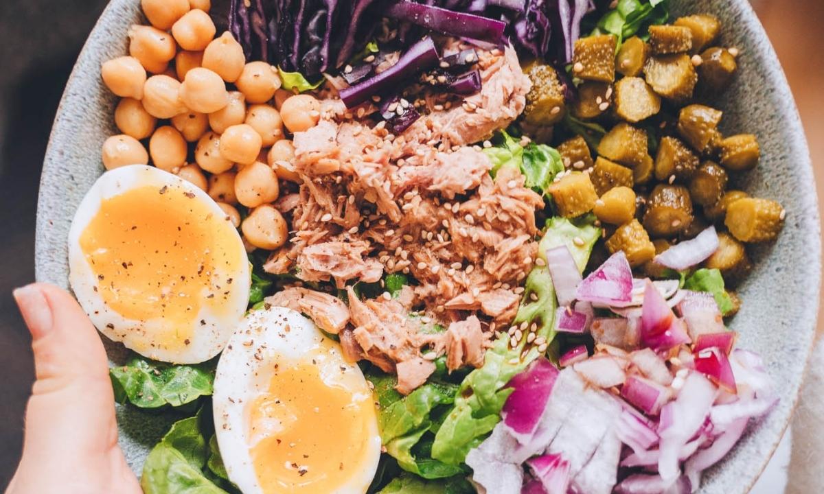 top view of a protein sald with tuna, eggs, chickpeas and veggies