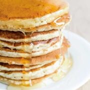 stack of pancakes made with Bisquick biscuit mix with some syrup on top