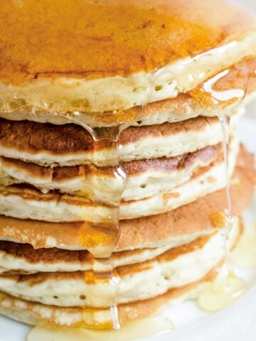 stack of pancakes made with Bisquick biscuit mix with some syrup on top