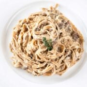top view of mushroom alfredo pasta in a white dish