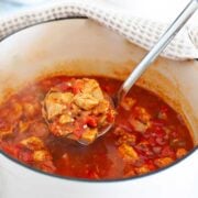 chicken goulash in a pot and a spoonful of this stew