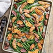 tow view of roasted potatoes and green beans in a baking sheet