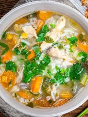 overhead view of lemon chicken and rice with bread on the side