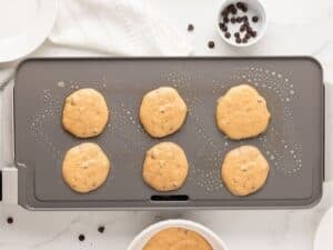 overhead view of cooking pumpkin pancakes with chocoalte chips