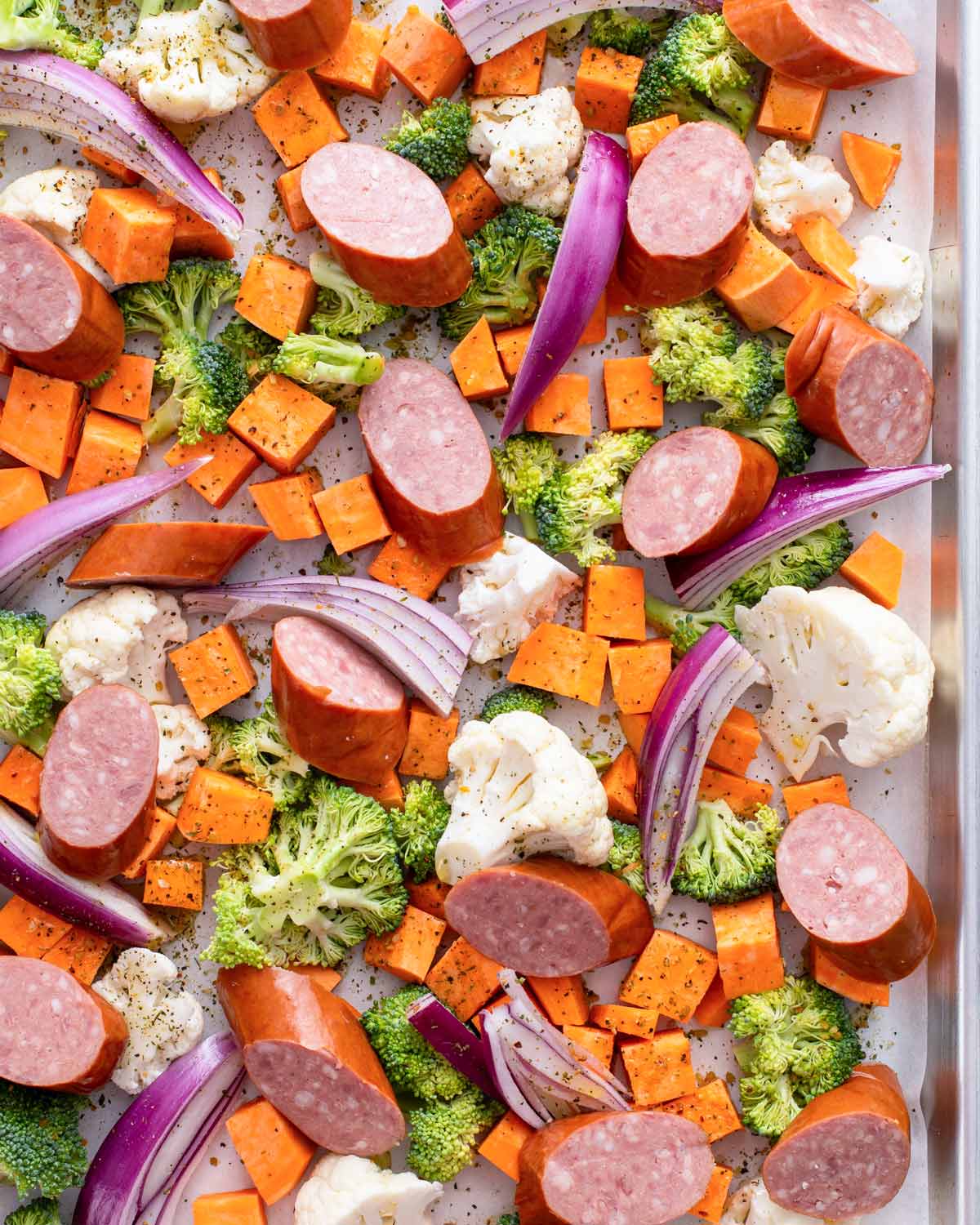 top view of sausage and vegetables in a sheet pan